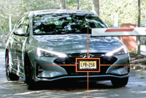 Vehicle approaching with license plate highlighted by AI recognition system